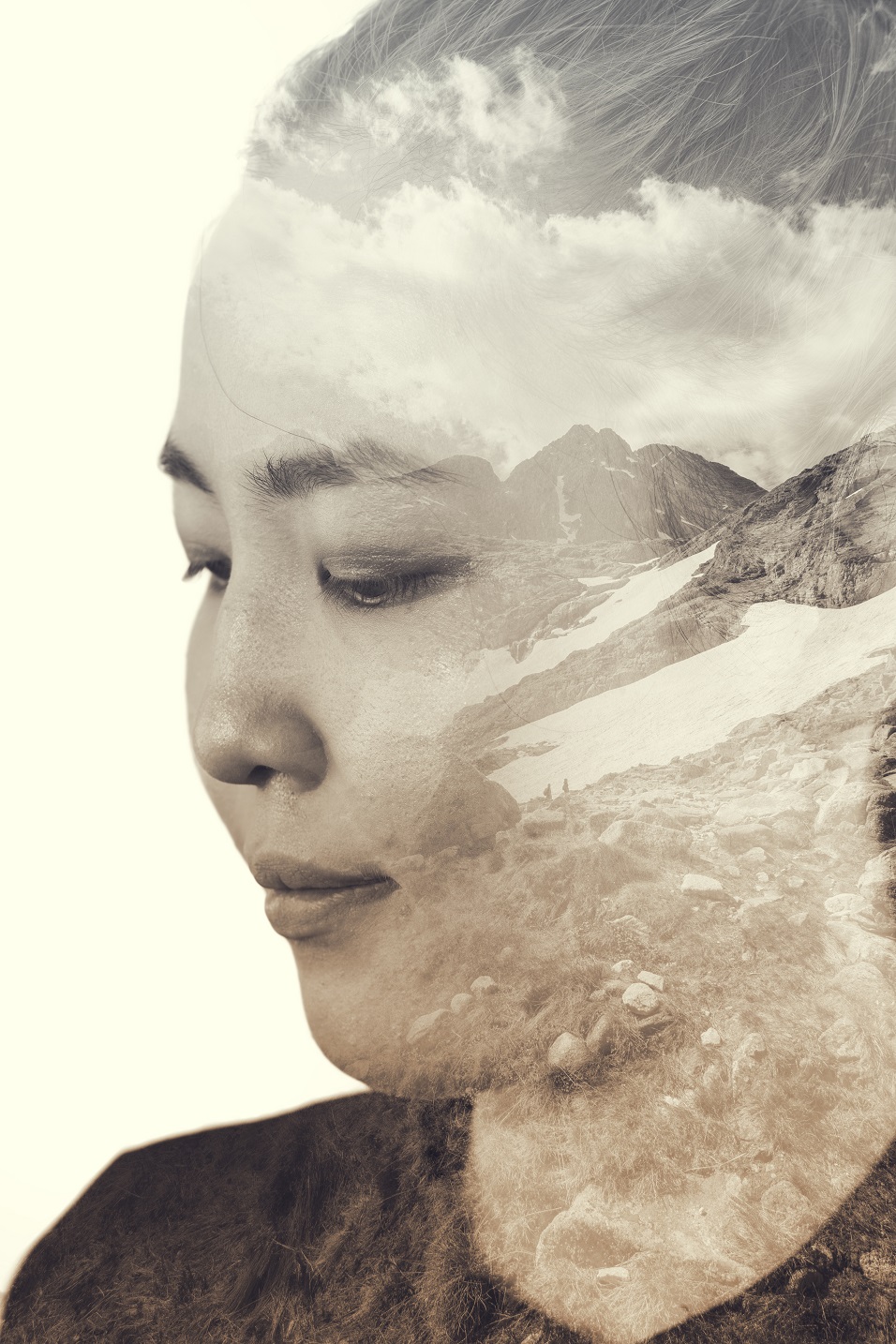Portrait of a young woman with the effect of double exposure, portrait of young Asian woman combined with photograph of mountains.